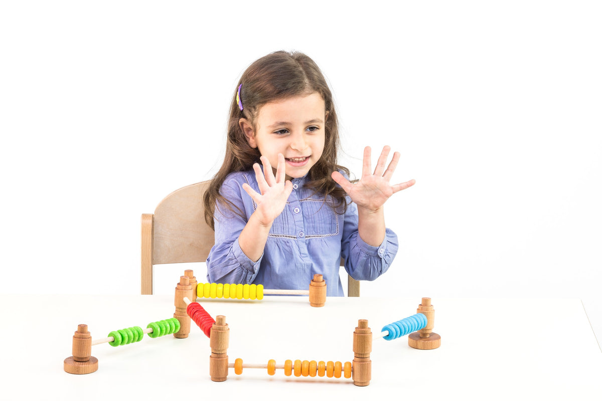 A child counting with wooden abacuses