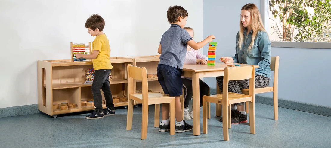 Children and an educator using different-sized wooden furniture