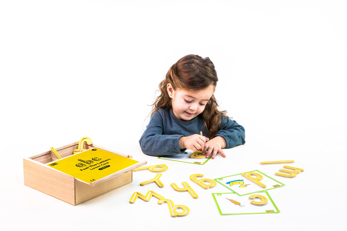 A child tracing a lowercase wooden letter using a stylus and picture card.